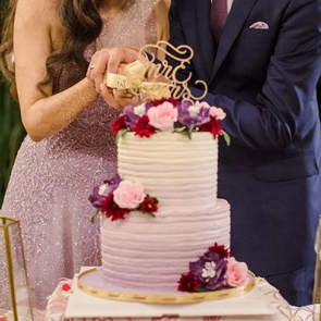 Newlyweds slicing into a wedding cake together